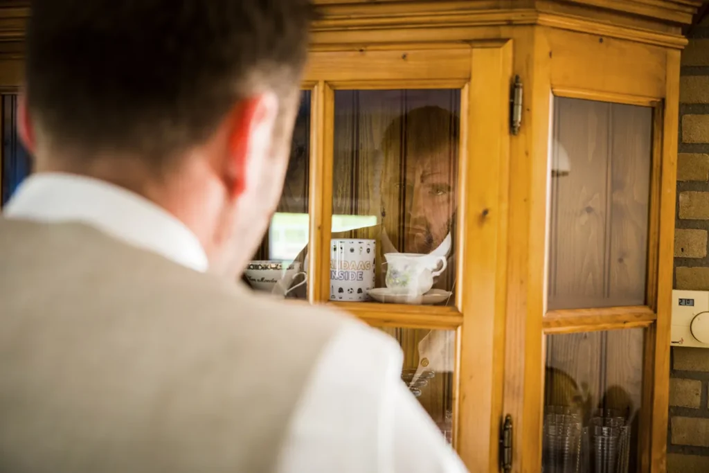 Bruidegom kijkt naar zijn spiegelbeeld. 