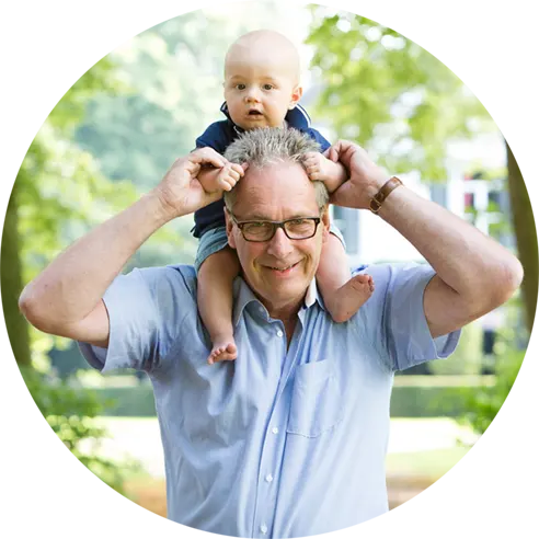 Baby zit op de nek van zijn opa.